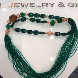 Emerald-color gold-enhanced necklace. Finished with accent stones. 18' Long.