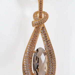 Smokey Quartz oval long stone set in 18 Gold pave setting enhanced by white topaz. Post.